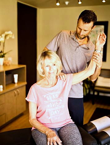 Dr. Gundelach adjusting a patient's arm